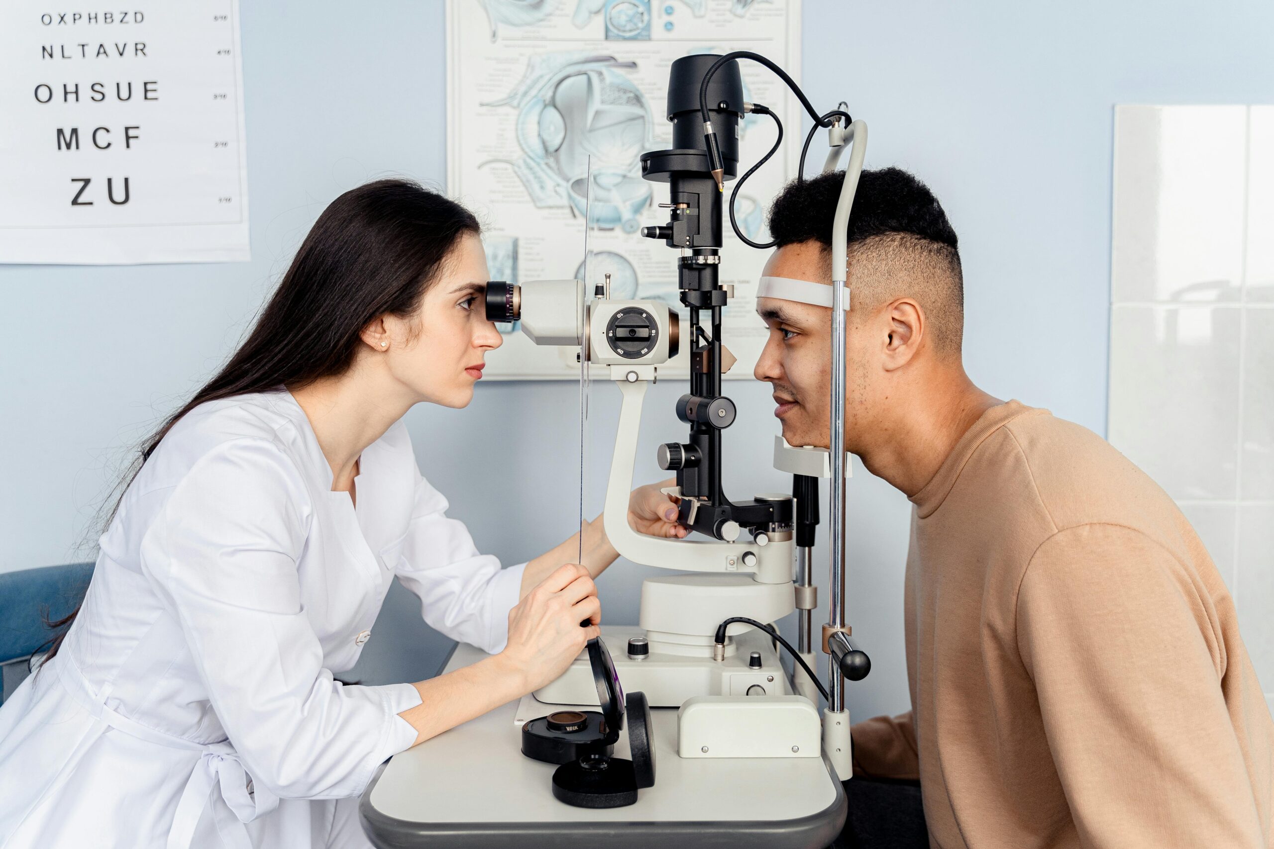 Professional eye examination conducted by an optometrist using modern equipment with a patient.